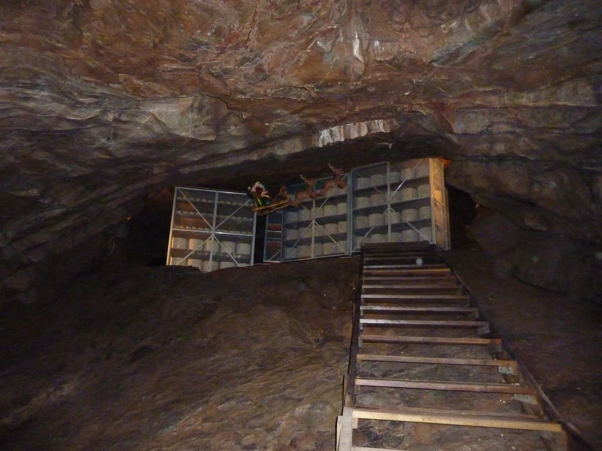 Cheddar cheese wheels maturing in the caves at Cheddar Gorge — the traditional method still used by Devon's clothbound cheesemakers