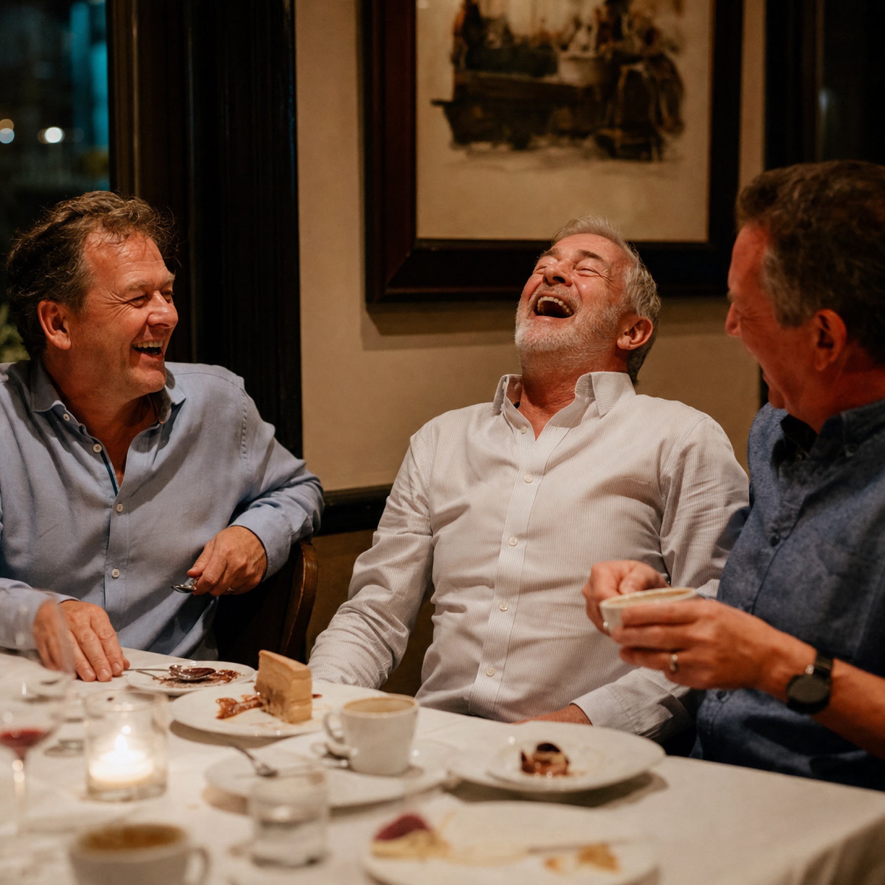 Guests laughing over dessert